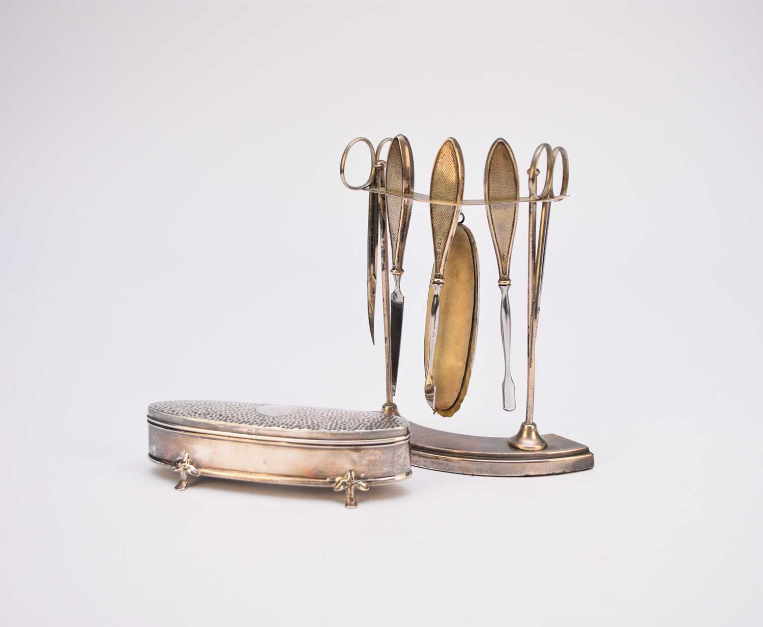 A silver mounted manicure set and dressing table box