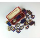 An assorted collection of silver, silver gilt and polychrome enamel Oddfellows badges