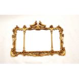 A reproduction rococo giltwood style mirror