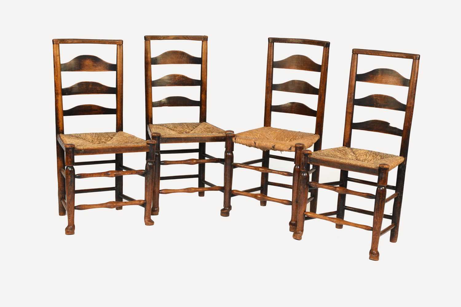 A set of four 19th century ash ladder back chairs