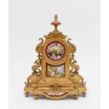 A French gilt metal and porcelain mantel clock