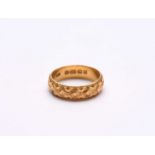 A 22ct gold decorative wedding band