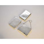 A silver card/notelet case and two silver card cases