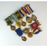 An assorted collection of gilt metal and polychrome enamel R.A.O.B. badges