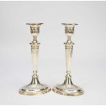 A pair of early 20th century silver mounted candlesticks