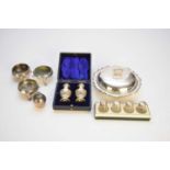 A collection of silver cruets and a silver muffin dish