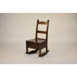 An early 19th century oak box rocking chair