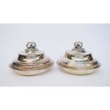 A pair of George III Paul Storr silver entree dishes and covers