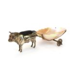 An Edwardian novelty silver pin cushion in the form of a bull with a mother of pearl cart