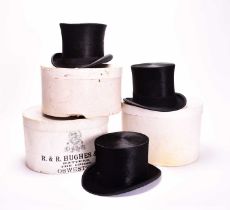 Three black silk top hats, boxed