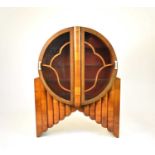 An Art Deco 'Rocket; walnut display cabinet