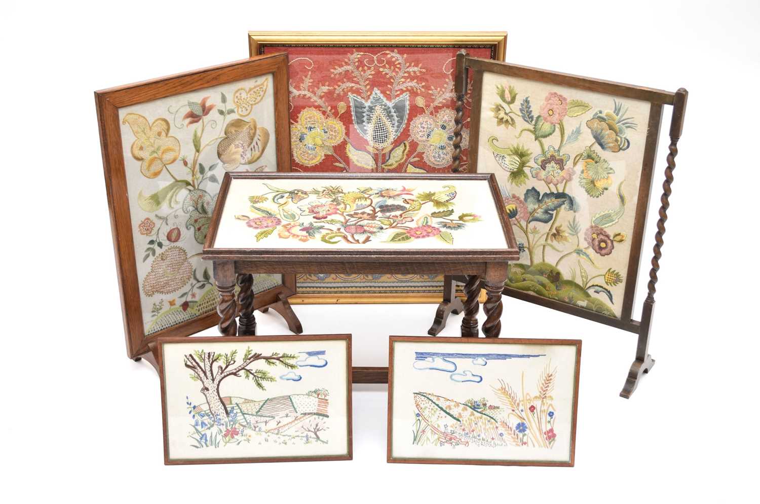 A collection of various embroidered textiles including two fire screens