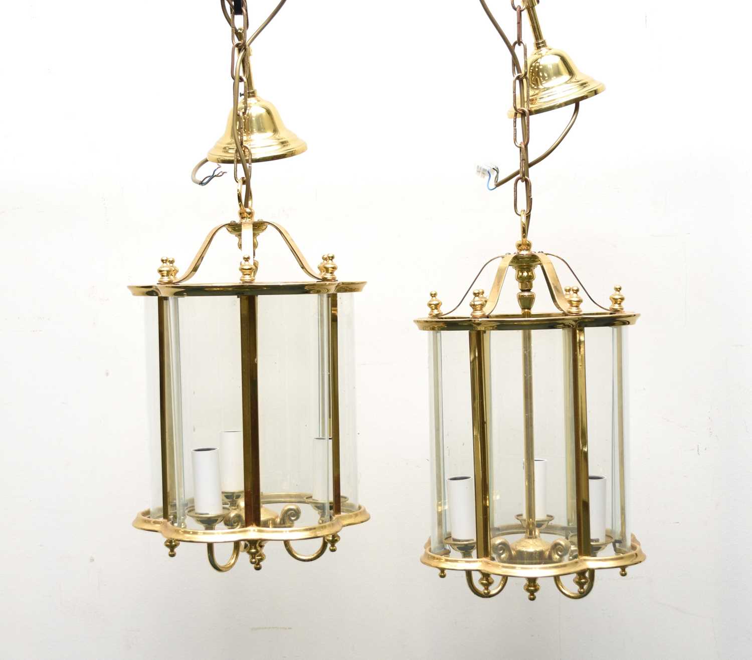 A pair of reproduction brass and glass lantern ceiling lights