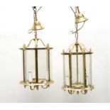 A pair of reproduction brass and glass lantern ceiling lights