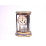 A French gilt brass and champleve enamel mantel clock