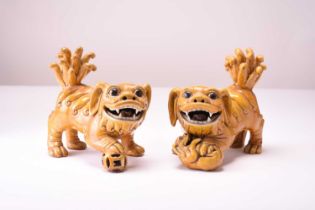 A pair of Chinese yellow sancai-glazed figures of guardian lions