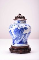 A Chinese blue and white jar with wood cover and stand, Kangxi (cracked)