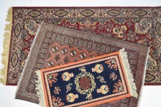 A Tabriz rug and two other smaller rugs