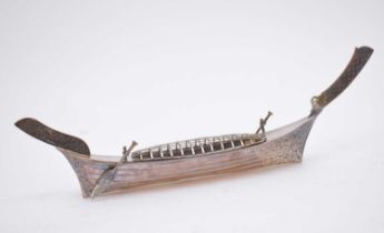 A white metal long boat