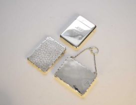 A silver card/notelet case and two silver card cases