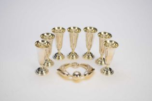 A Tiffany & Co silver rattle and seven white metal tot cups