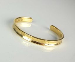 A Tiffany & Co 18ct yellow gold torque bangle