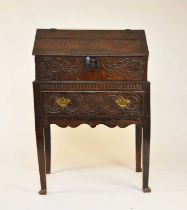 An early 18th century carved oak desk or bible box on stand
