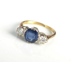 An 18ct gold three stone sapphire and diamond ring