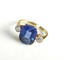 A three stone synthetic sapphire and diamond ring