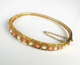 A Victorian style graduated coral and split pearl hinged bangle