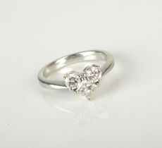 A three stone diamond ring of heart form
