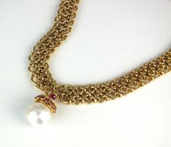 An 18ct gold necklace with baroque cultured pearl and ruby pendant