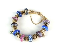 A 14ct gold Pandora herringbone bracelet with twenty charms
