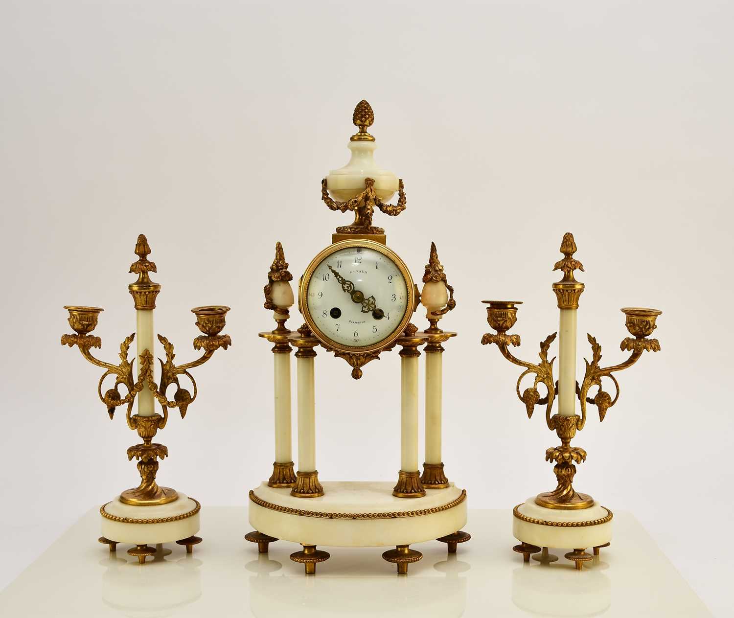 A late 19th century French Portico clock garniture