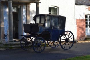 A single Brougham type horse-drawn carriage