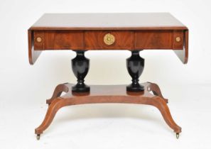 A Regency style parcel ebonised mahogany sofa table