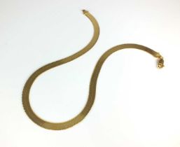A yellow metal flat link chain necklace