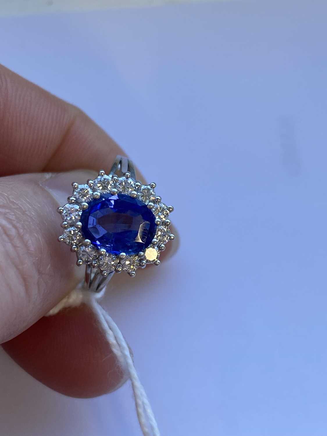 An oval sapphire and diamond cluster ring - Image 2 of 9