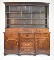 A George III oak breakfront dresser and rack, North Wales