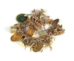 A 9ct gold charm bracelet with attached charms