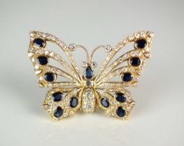 A large diamond and sapphire butterfly brooch