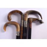 FOUR 19TH CENTURY MIDDLE EASTERN CARVED RHINOCEROS HORN WALKING CANES. 90 cm long. (4)