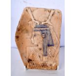 A carved Egyptian tile fragment 16 x 12 cm