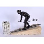 A RARE ART DECO BRONZE AND MARBLE FIGURE OF A SKIER modelled on the slopes. 24 cm x 27 cm.