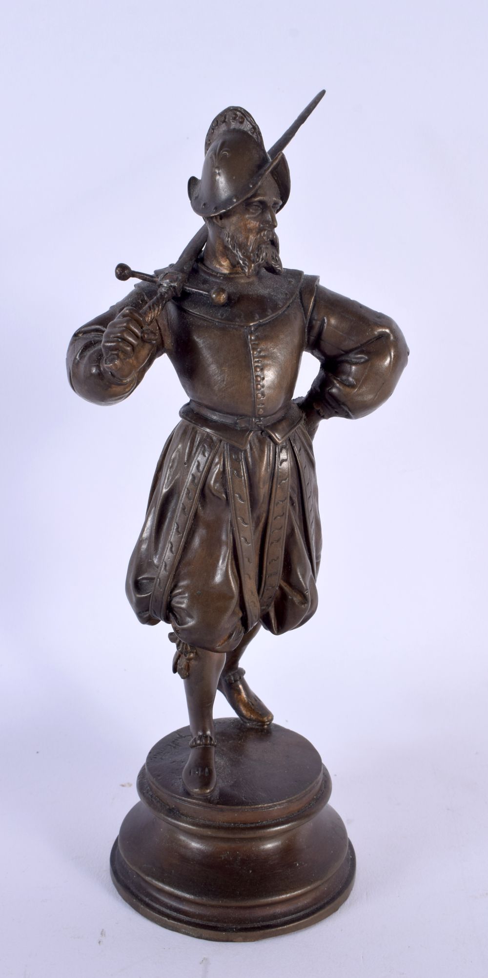 AN ANTIQUE FRENCH BRONZE FIGURE OF A MEDIEVAL SOLDIER modelled holding a sword. 23 cm high.