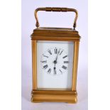 AN ANTIQUE FRENCH REPEATING BRASS CARRIAGE CLOCK. 18 cm high inc handle.