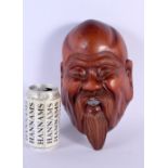 AN EARLY 20TH CENTURY JAPANESE MEIJI PERIOD CARVED HARDWOOD MASK formed as a bearded male. 27 cm x 1
