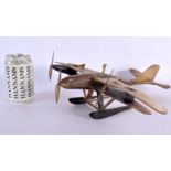 A RARE ART DECO CARVED BUFFALO HORN AERONAUTICAL PLANE DESK STAND. 36 cm x 36 cm.