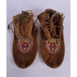 A PAIR OF NORTH AMERICAN TRIBAL MOCCASINS. 28 cm x 14 cm.