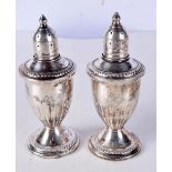 A PAIR OF GLASS LINED, WEIGHTED SILVER CONDIMENTS. Stamped Sterling, 12cm x 47cm, total weight 269g